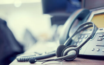 close up soft focus on headset with telephone devices at office