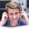 young smiling male call centre operator doing his job with a headset